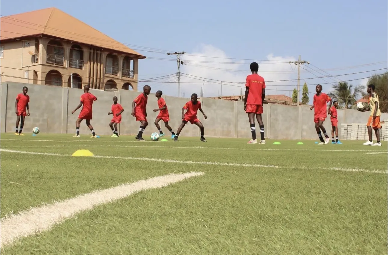 Young players in red training kit working on ball-control drills
